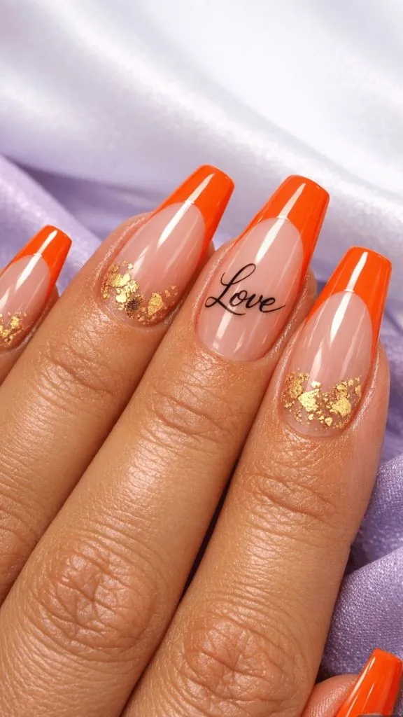 Orange French tip coffin nails with gold leaf accents and Love text