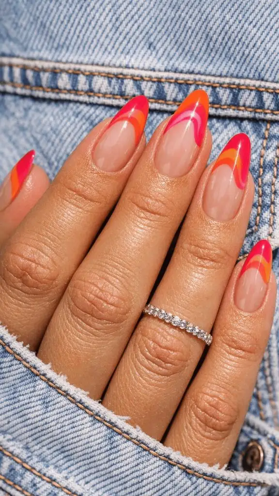 Almond nails with pink, orange, and red swirl French tips