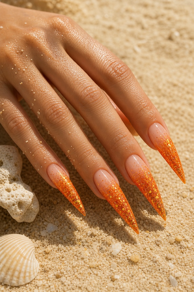 Sunset Glitter Stiletto Nails 2026: orange ombre glitter claws Sunset Glitter Stiletto nails for summer. Summer vibes nails 2026 in orange glitter ombre on long claws.