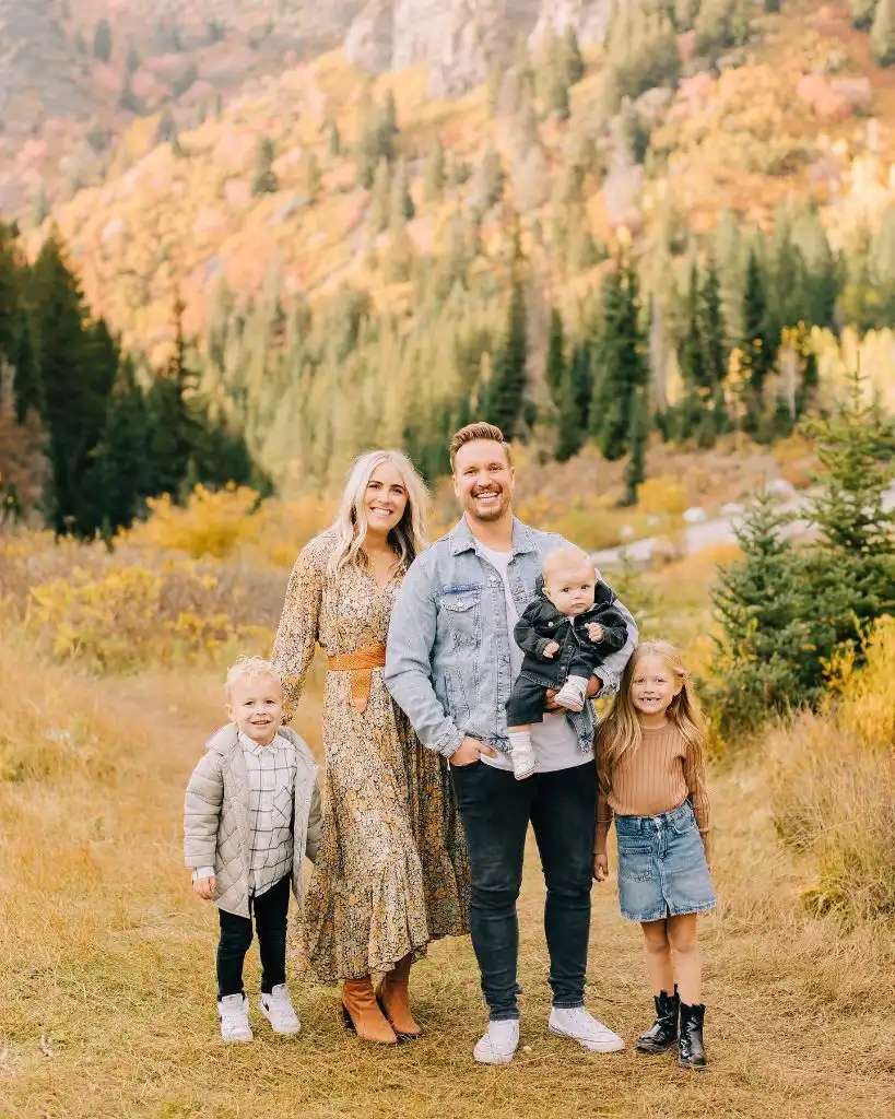 Family of five with three children in fall mountain setting with autumn foliage