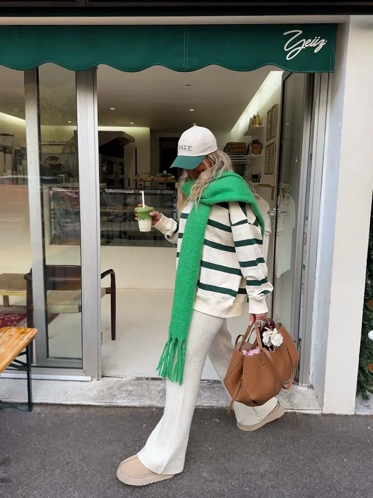 Striped sweater, cream knit pants, green scarf and Vogue cap