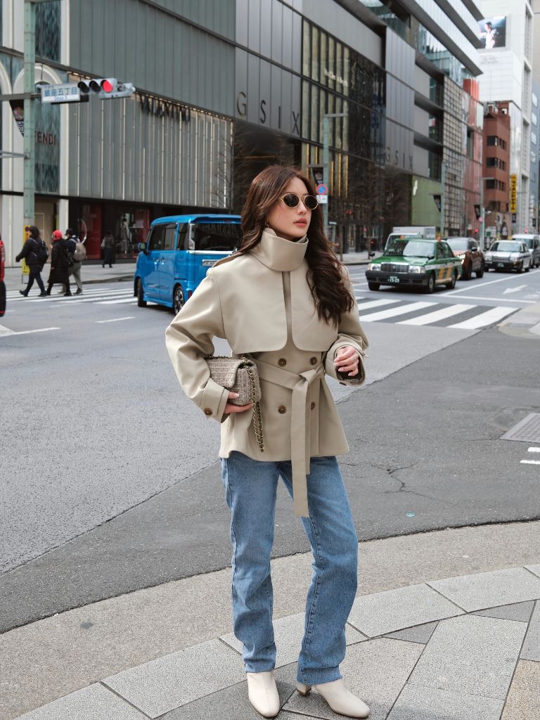 Beige belted jacket with jeans in Japan