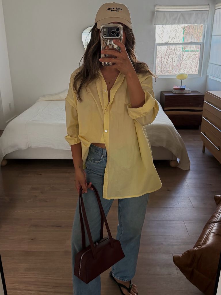 Yellow oversized button-down with jeans and baseball cap