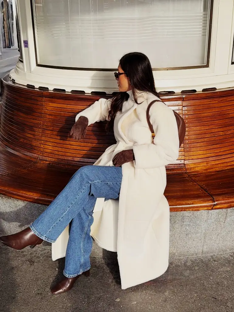 Long ivory teddy coat with blue jeans and brown leather boots