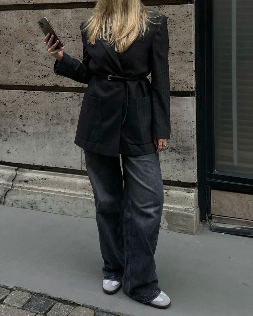Dark belted blazer with wide-leg dark wash jeans and white ballet flats