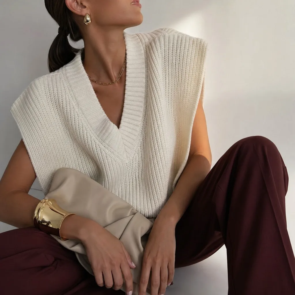 Cream ribbed knit vest with gold cuff and burgundy trousers