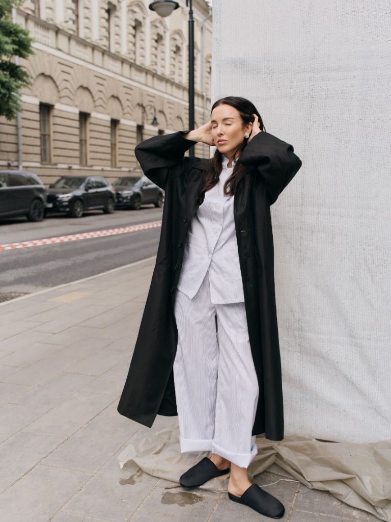 Black coat with white pajama-style outfit