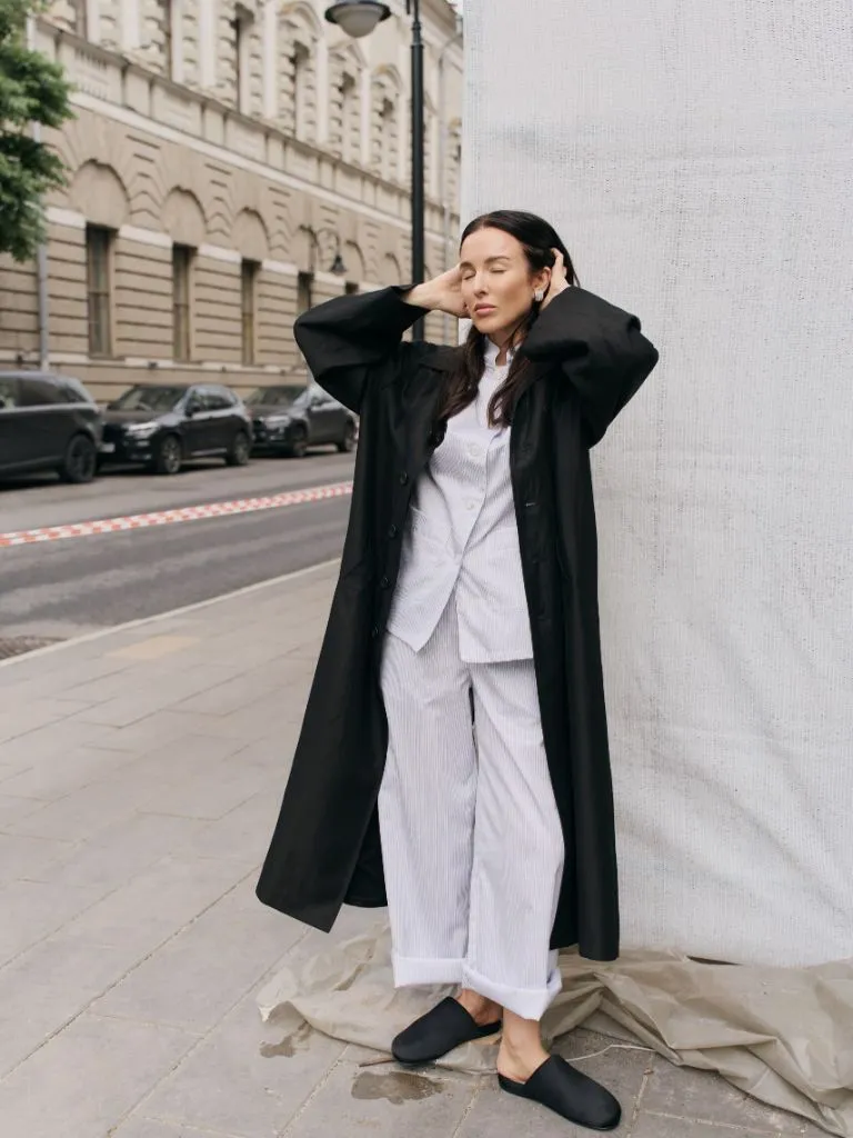 Black coat with white pajama-style outfit