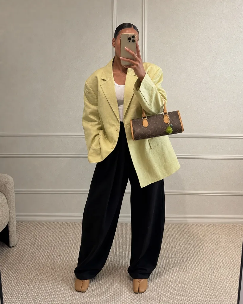 Pale yellow oversized linen blazer with black wide-leg trousers and Louis Vuitton bag