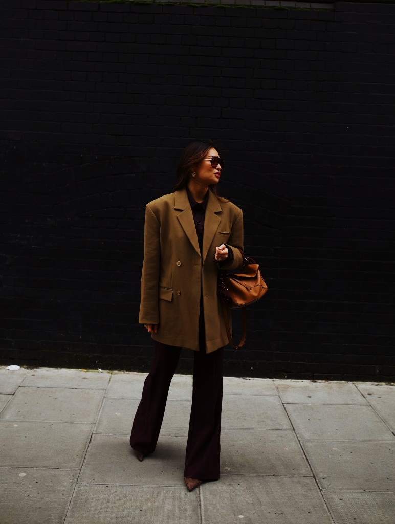 Olive oversized blazer with burgundy wide-leg trousers and cognac Loewe bag