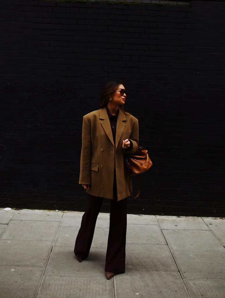Olive oversized blazer with burgundy wide-leg trousers and cognac Loewe bag