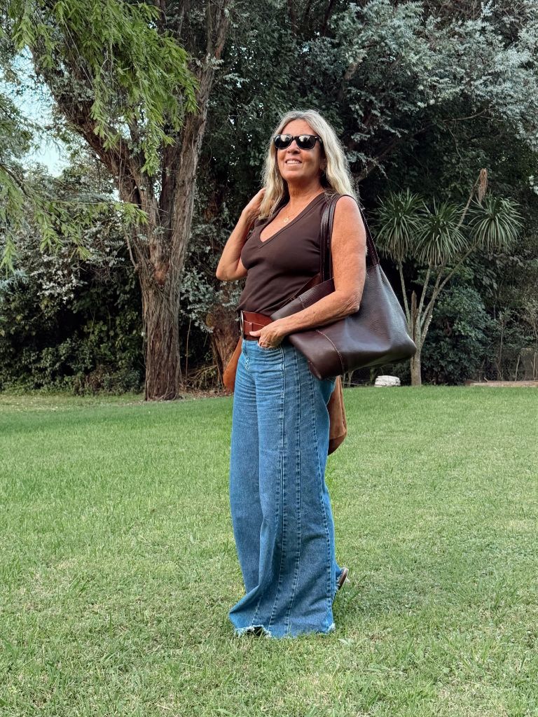 Brown tank top with wide-leg blue jeans and brown leather tote