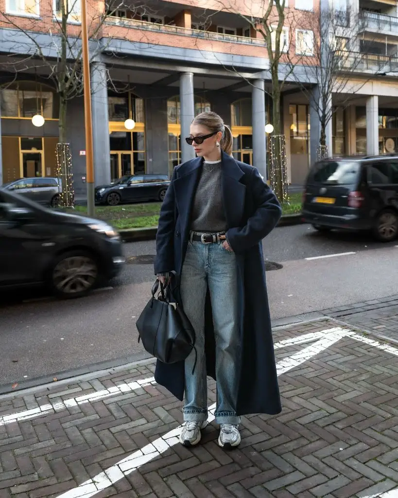 Navy coat with grey sweater and wide-leg jeans