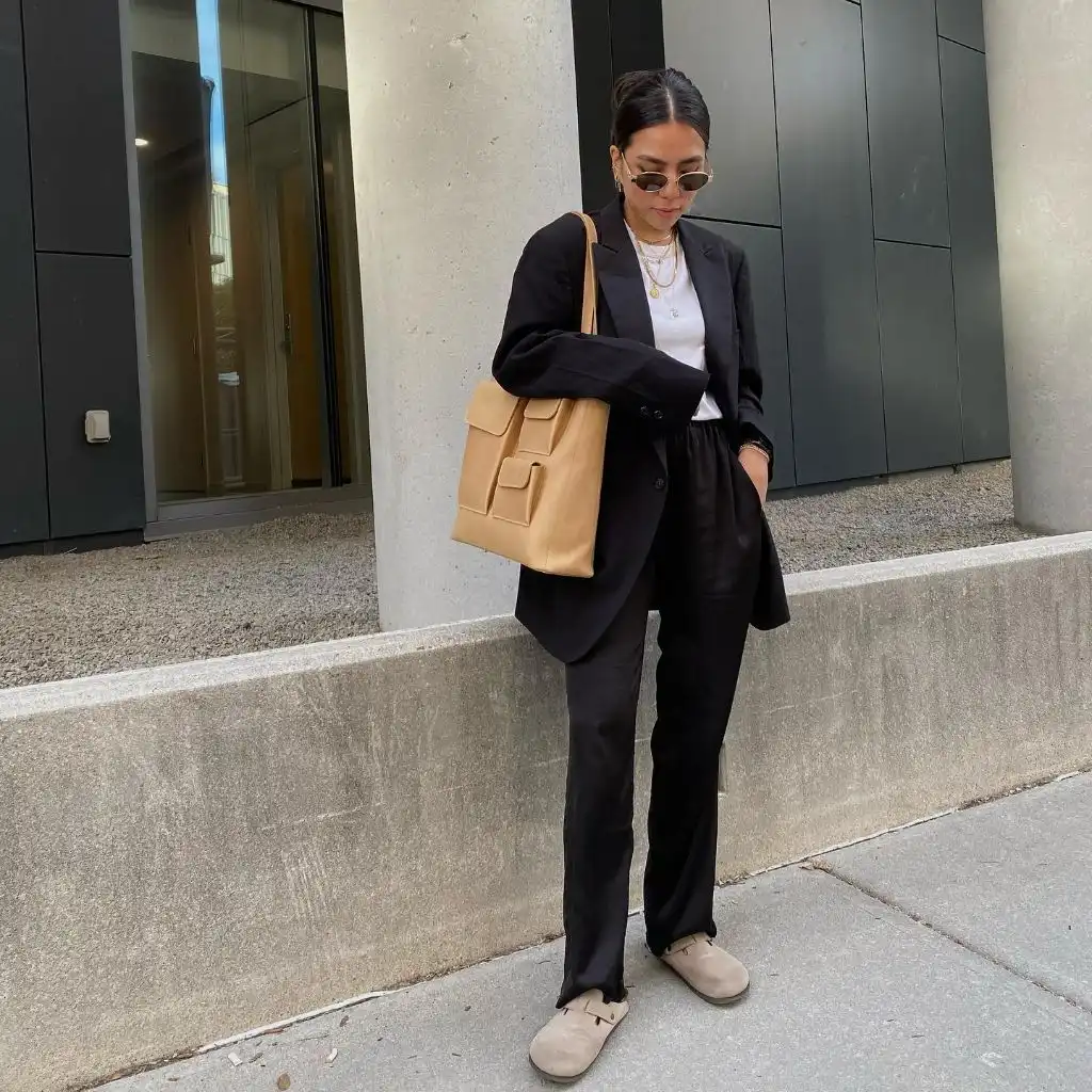 Black blazer suit with beige accessories