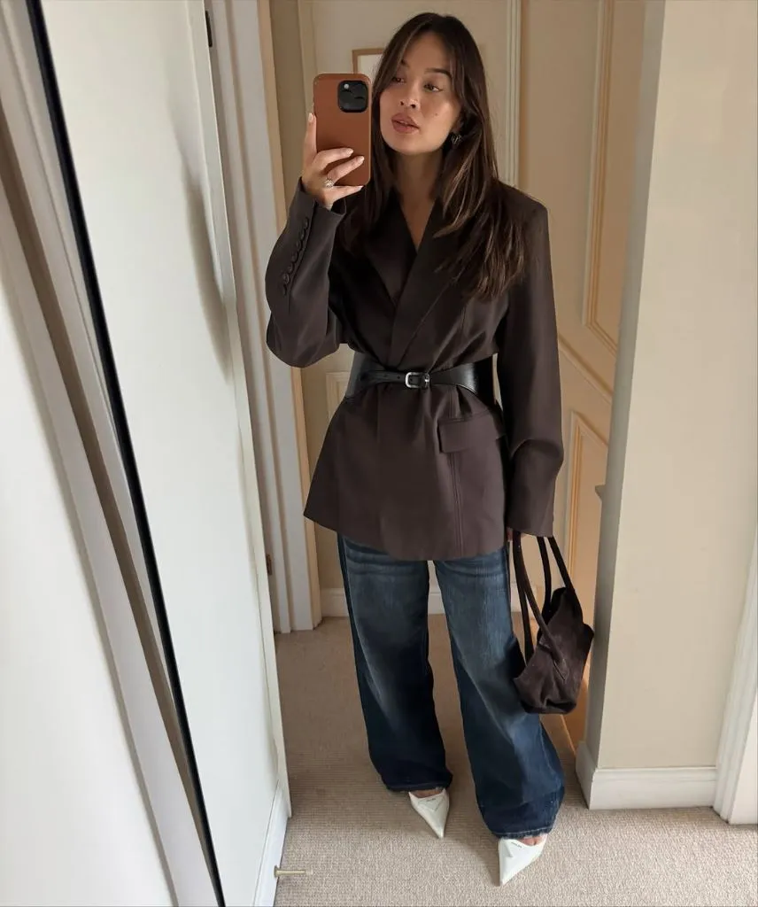 Belted chocolate blazer with wide-leg jeans and white pointed heels