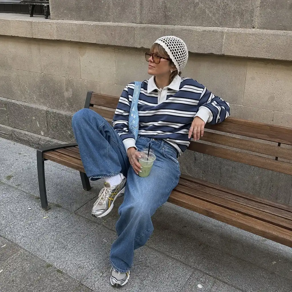 Striped rugby polo with jeans and crochet beanie on bench