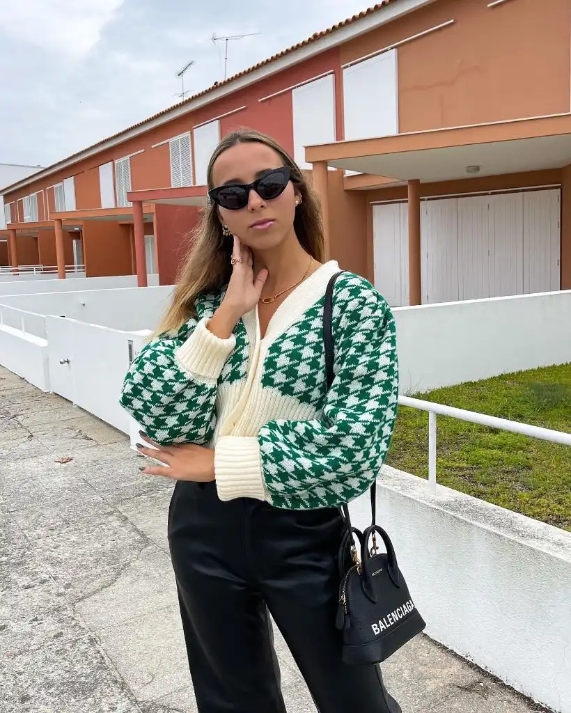 Green and white houndstooth cardigan with black trousers and Balenciaga bag