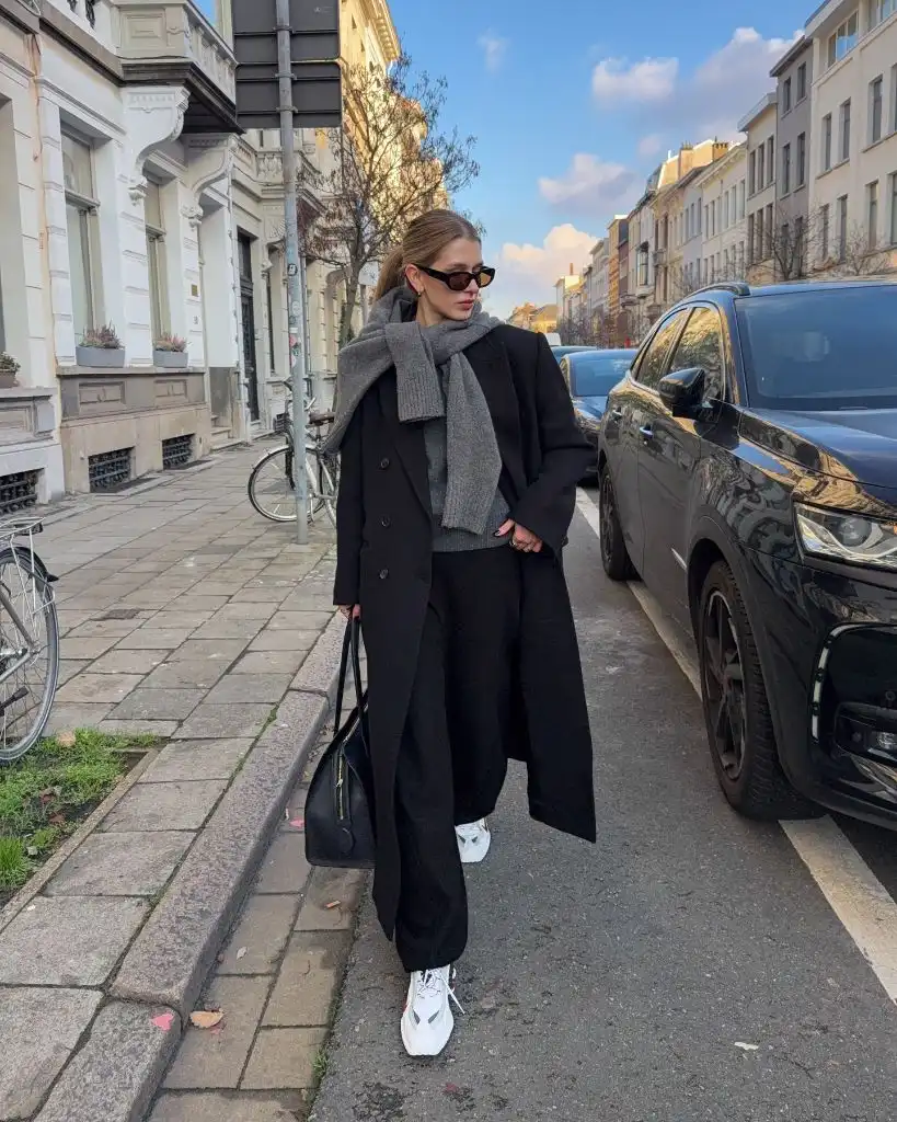 Black coat with black trousers and grey sweater