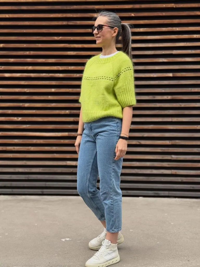 Neon lime green short-sleeve knit sweater with light wash jeans