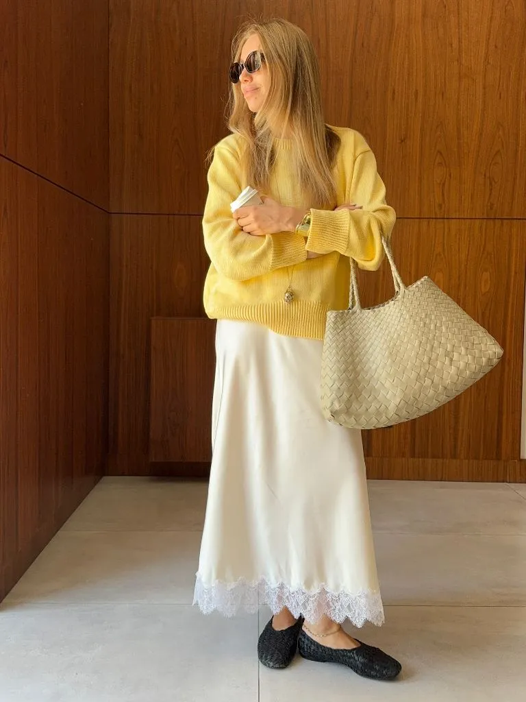 Yellow sweater with cream satin lace-trimmed midi skirt