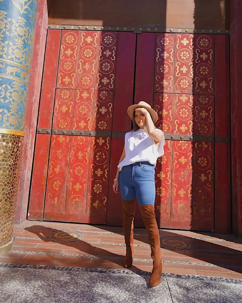 White blouse, denim shorts and over-the-knee suede boots