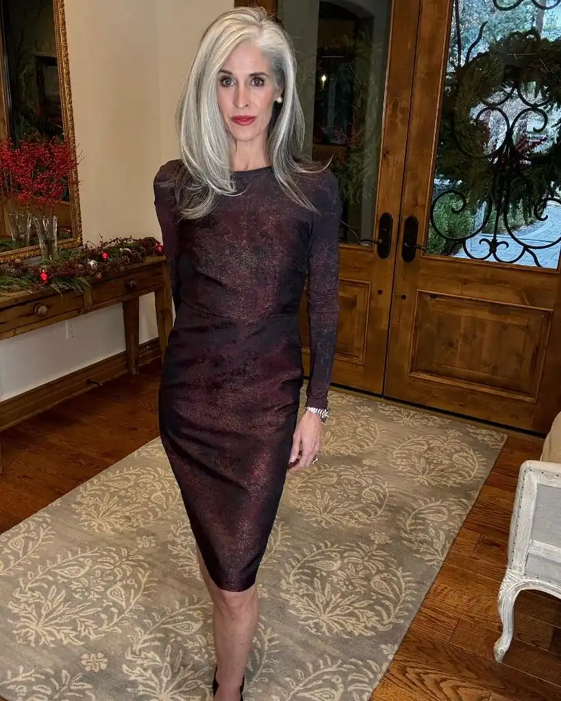 Deep burgundy long-sleeve fitted midi dress in a festive interior