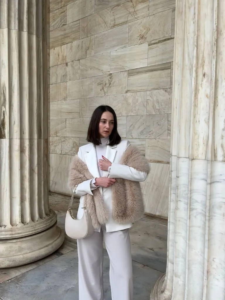White blazer suit with blush fur stole and cream hobo bag