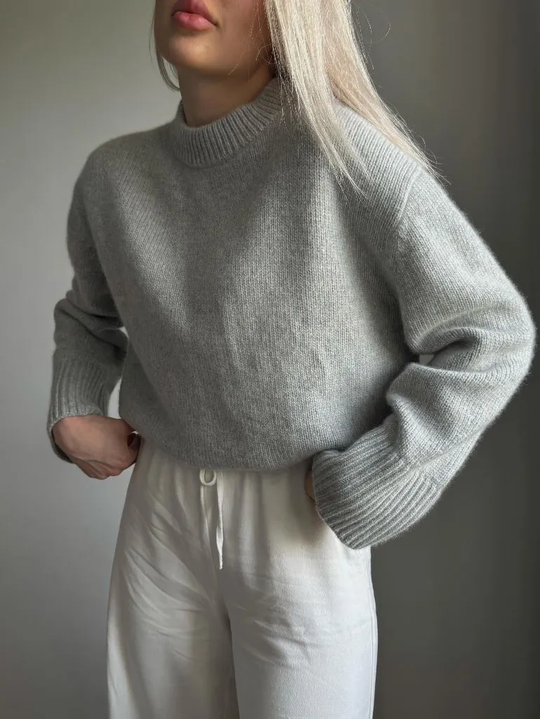 Light grey cropped mock-neck sweater with white trousers
