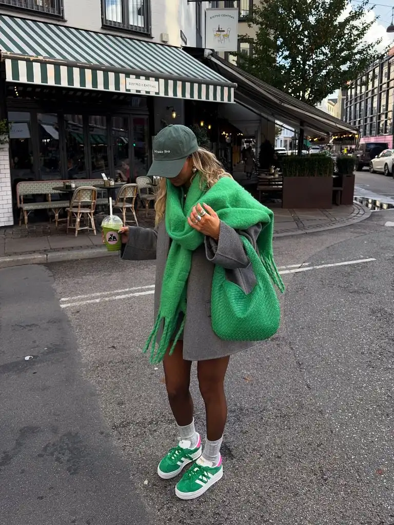 Grey sweatshirt dress with green scarf, green bag, and green Adidas sneakers