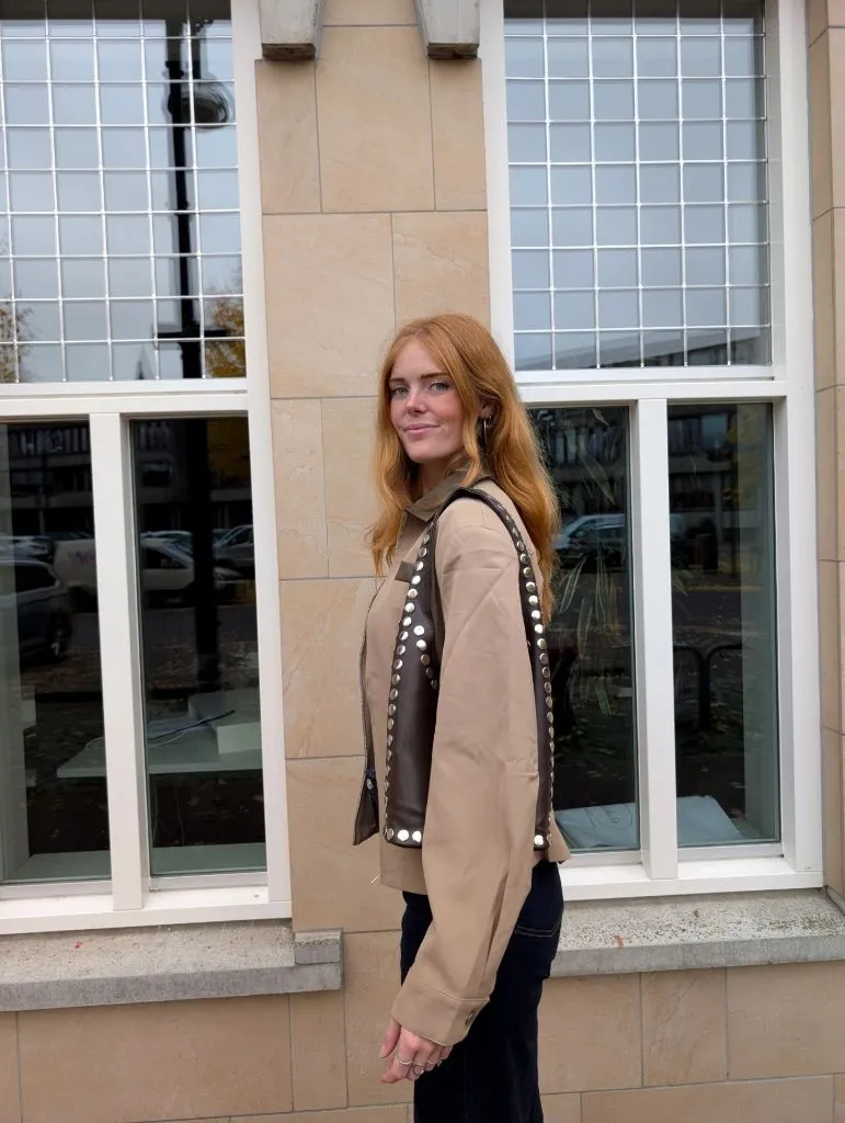 Tan blazer with brown studded leather panel and dark jeans