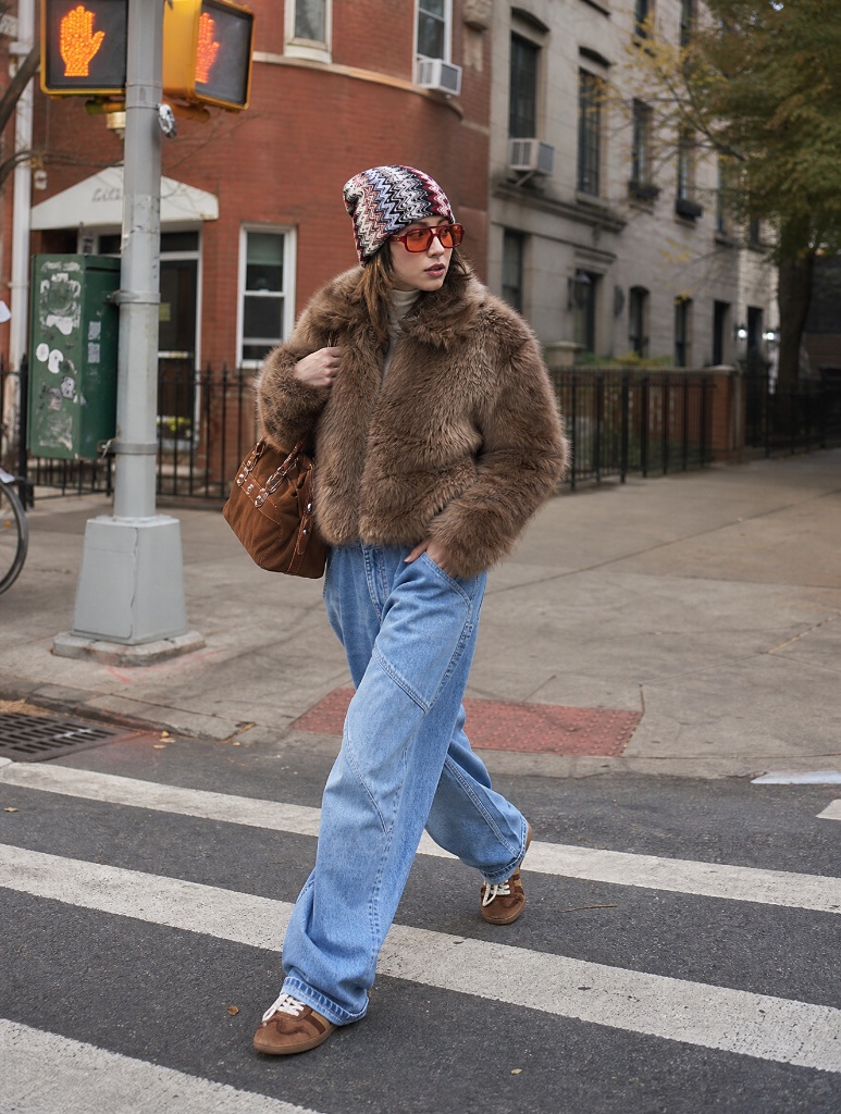 Brown faux fur jacket with patterned beanie and light jeans