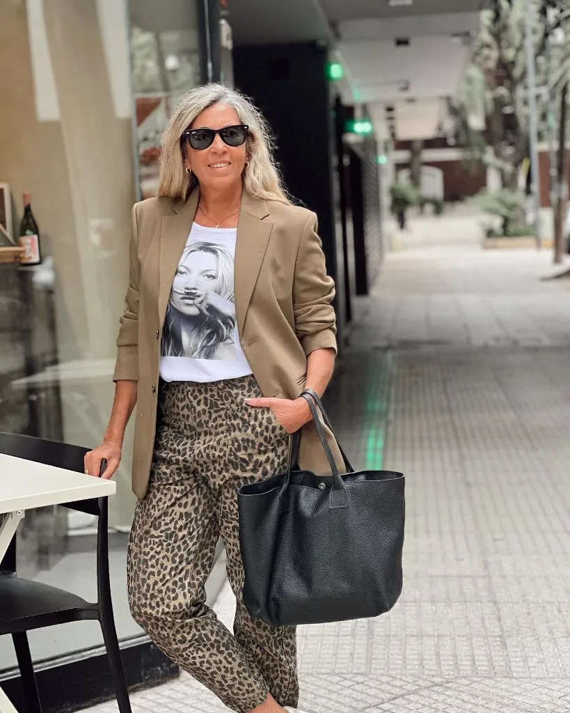 Camel blazer with leopard print trousers and graphic tee with black tote