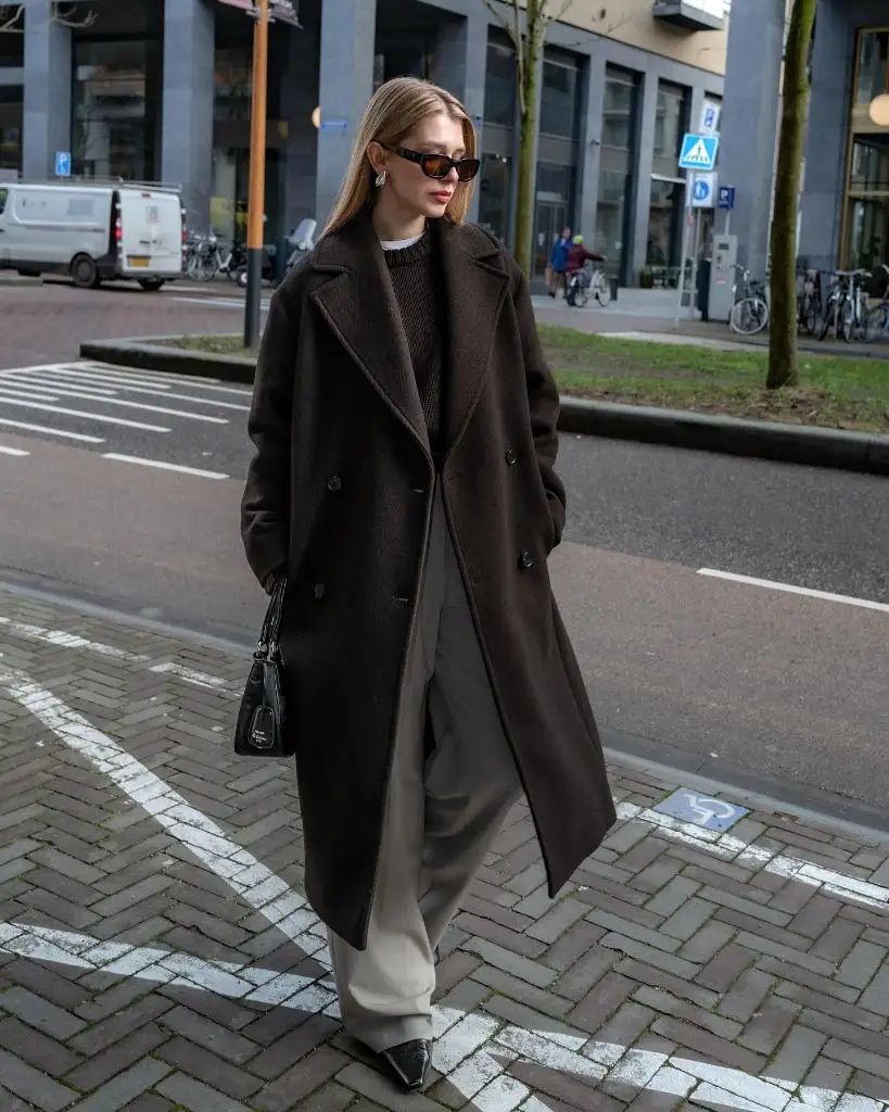 Dark brown coat with cream trousers