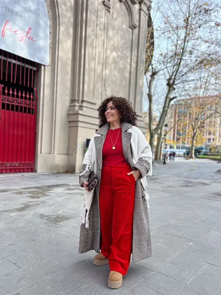 Red knit top and red corduroy wide-leg trousers with plaid coat