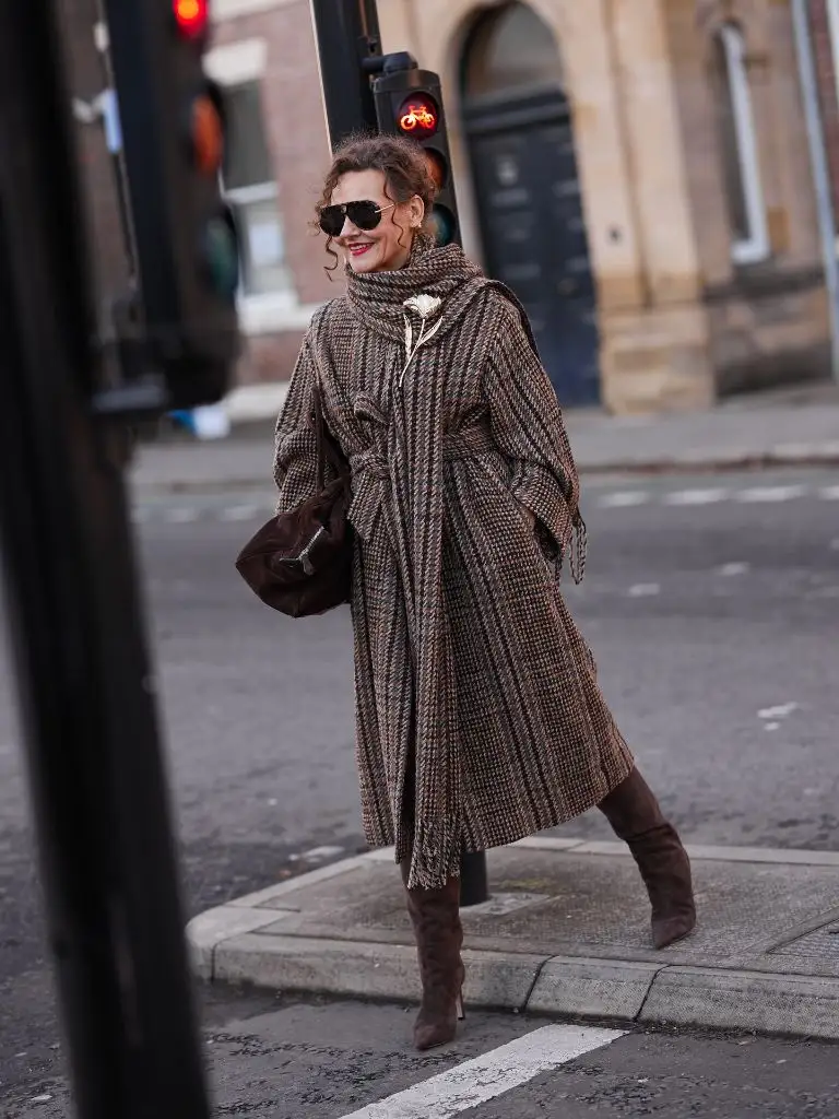 Brown tweed oversized coat with suede boots and brooch