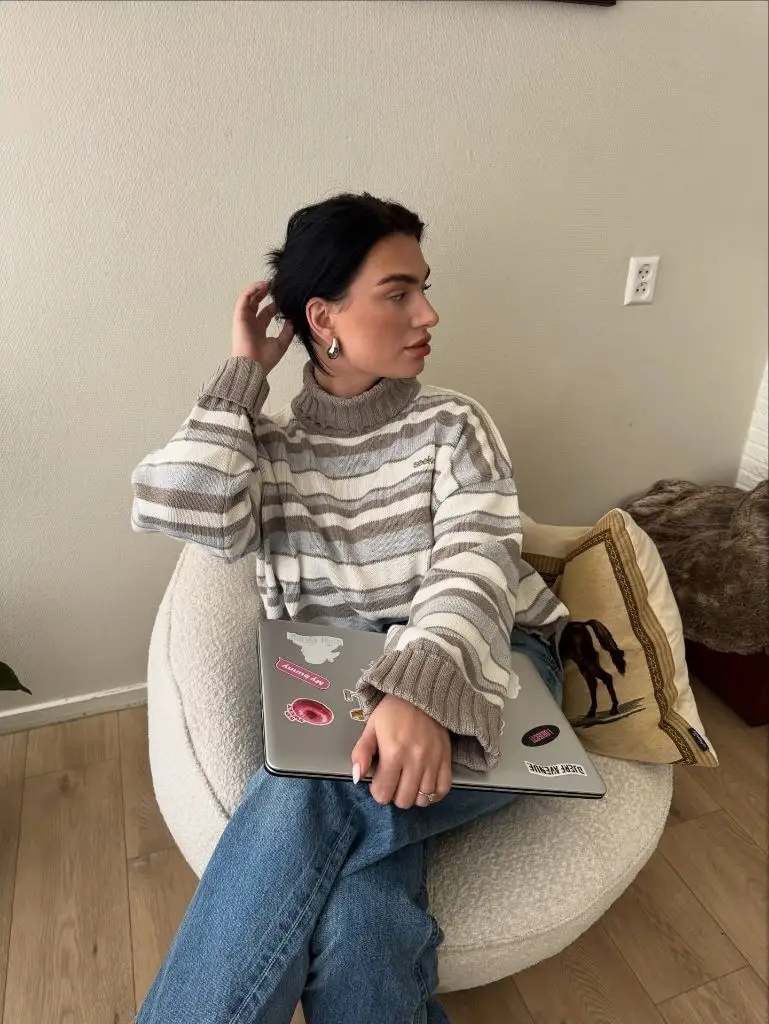 Striped turtleneck sweater with laptop on bean bag