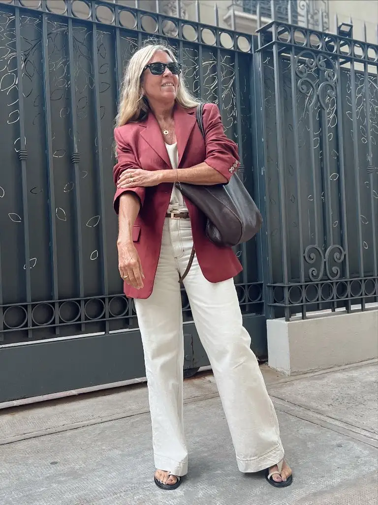 Terracotta blazer over white top with cream wide-leg trousers and sandals