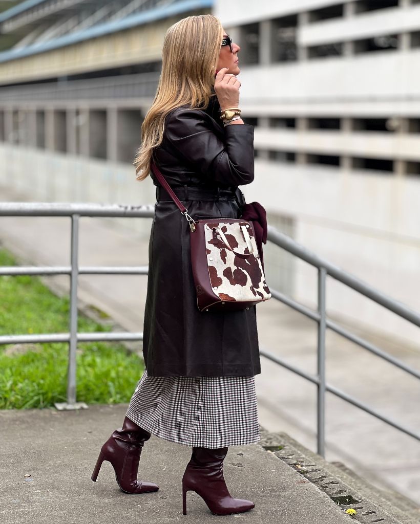 Burgundy leather trench over houndstooth midi skirt with burgundy heeled boots