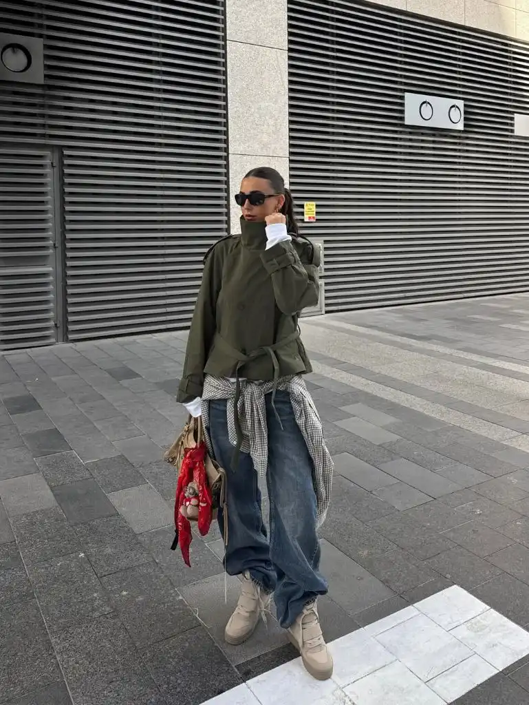 Olive green military jacket with wide-leg jeans, beige platform boots, and gingham shirt tied at waist