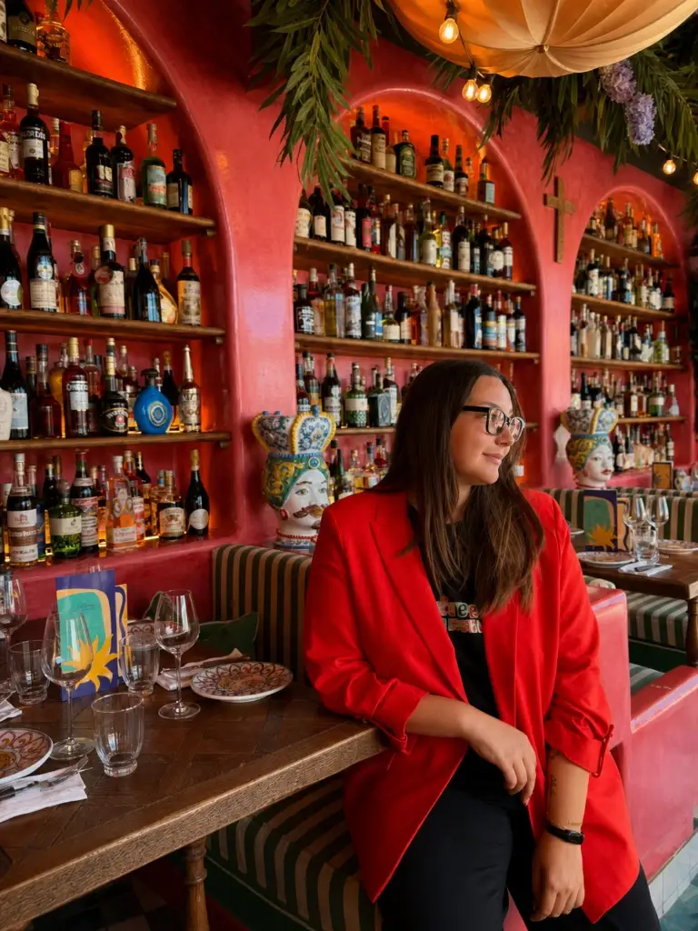 Bright red blazer over black outfit in a colorful restaurant setting