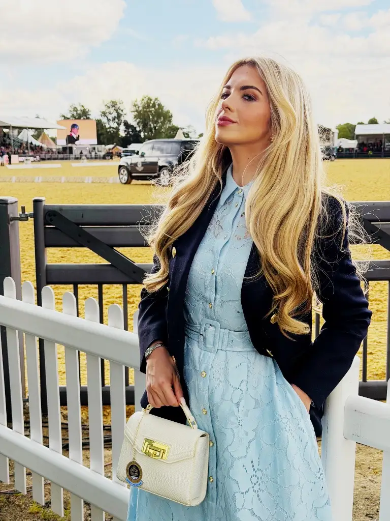 Light blue lace dress with navy blazer at an outdoor event