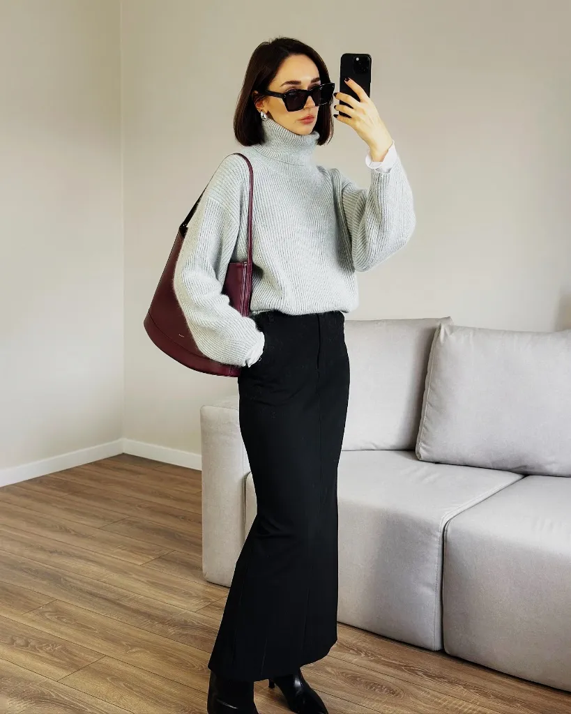 Grey ribbed turtleneck with black midi skirt and burgundy shoulder bag