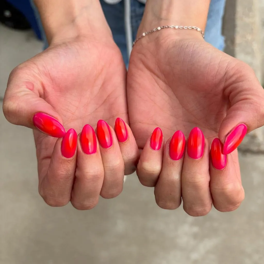 Hot coral jelly shine nails on almond shaped nails August nails color 2026 ideas