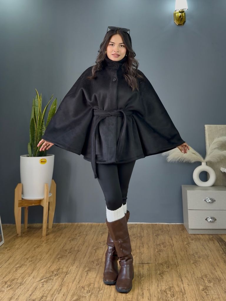 Black belted cape style coat with leggings and brown riding boots