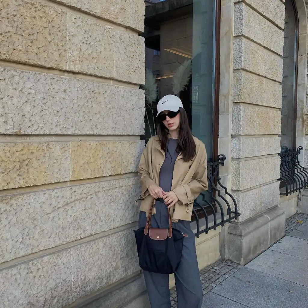 Khaki field jacket style coat over grey outfit with Longchamp bag