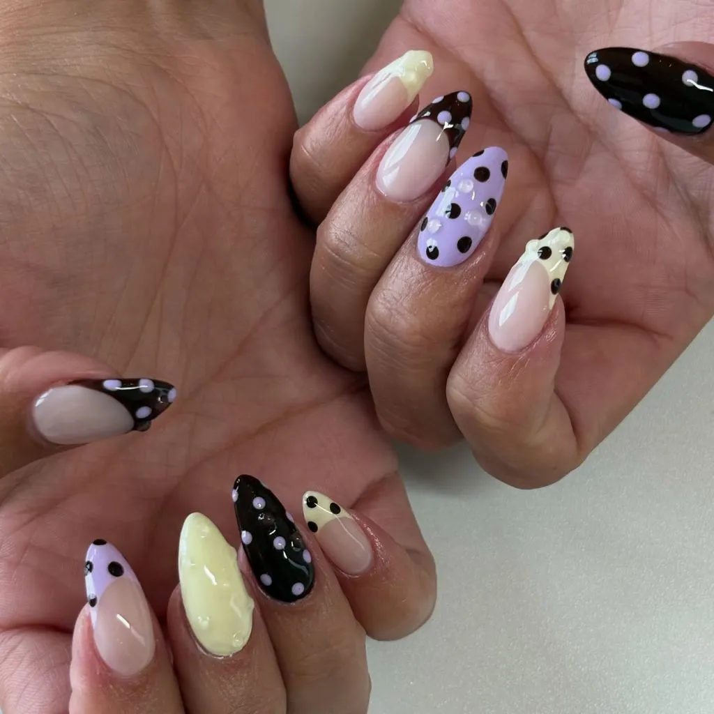 Lavender black and lemon polka dot mixed nail art on almond nails August nails color 2026 ideas
