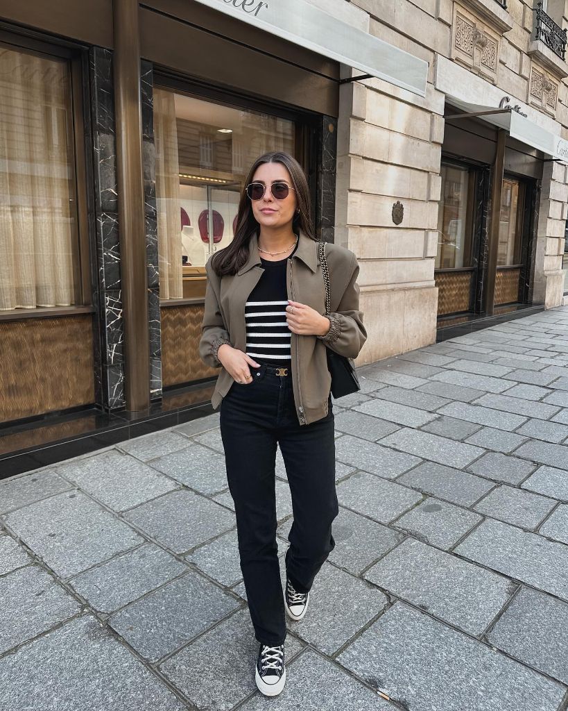 Olive shacket over Breton stripe top with black jeans and Converse