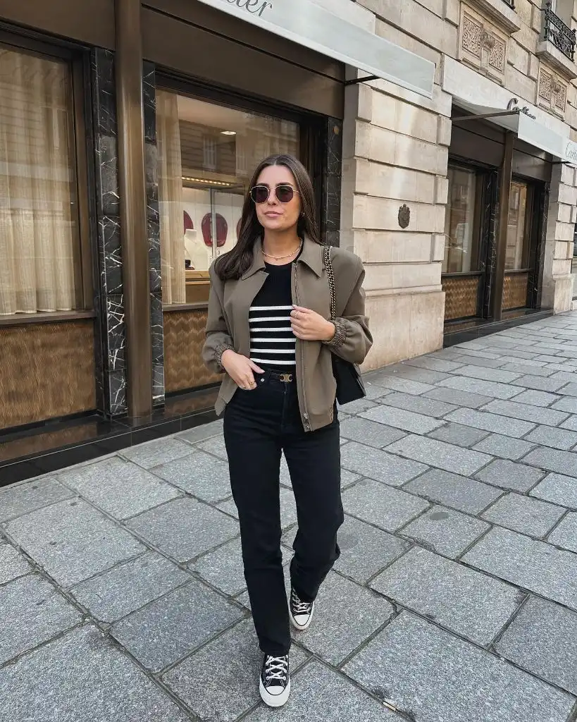 Olive shacket over Breton stripe top with black jeans and Converse