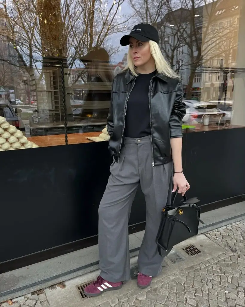 Fall professional outfit black leather jacket grey wide-leg trousers cap burgundy sneakers