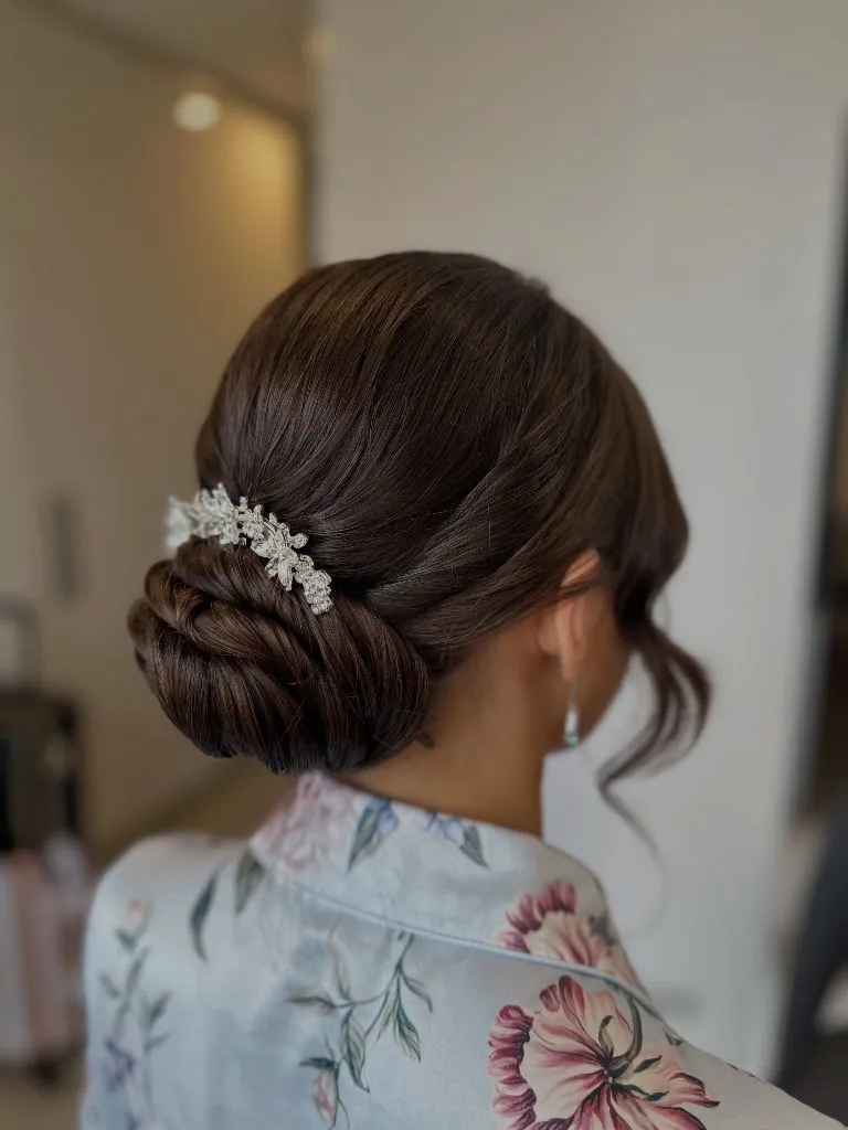 Fall Hairstyles for Wedding Guests 2026 Polished Low Twisted Bun with Crystal Hair Comb